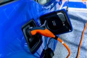 a blue electric car being charged
